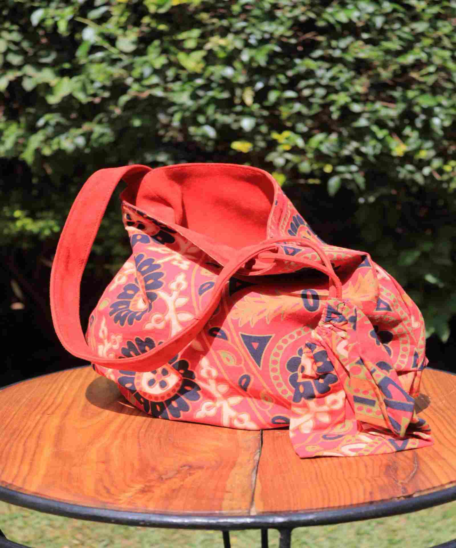 Borsa reversibile in tessuto con motivo multicolore caldo, manici morbidi e forma rilassata, progettata e spedita dall’Italia.